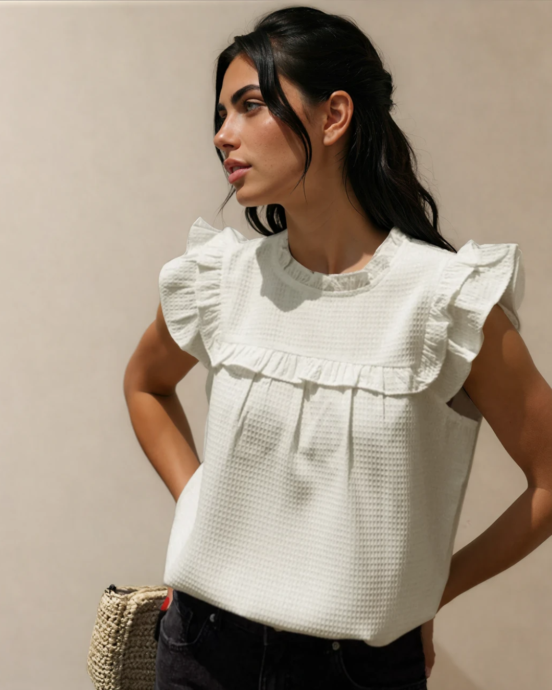 Front view of the Clover waffle-textured blouse featuring a frilled neckline, delicate ruffle trim detailing, and a comfortable, relaxed fit.