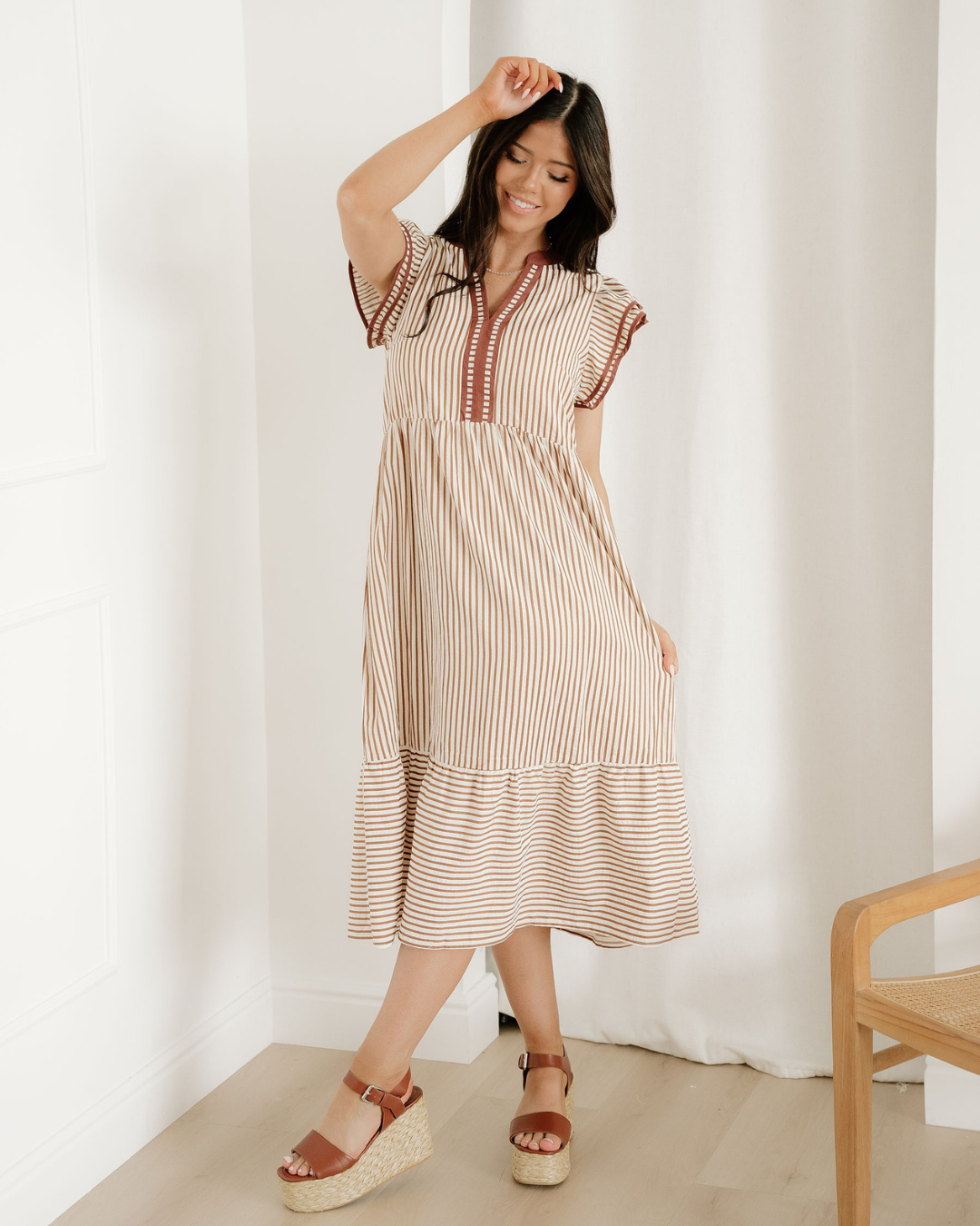Women's brown striped midi dress featuring short double ruffled sleeves, a V-neckline with a distinct contrast trim, and a relaxed summer silhouette.