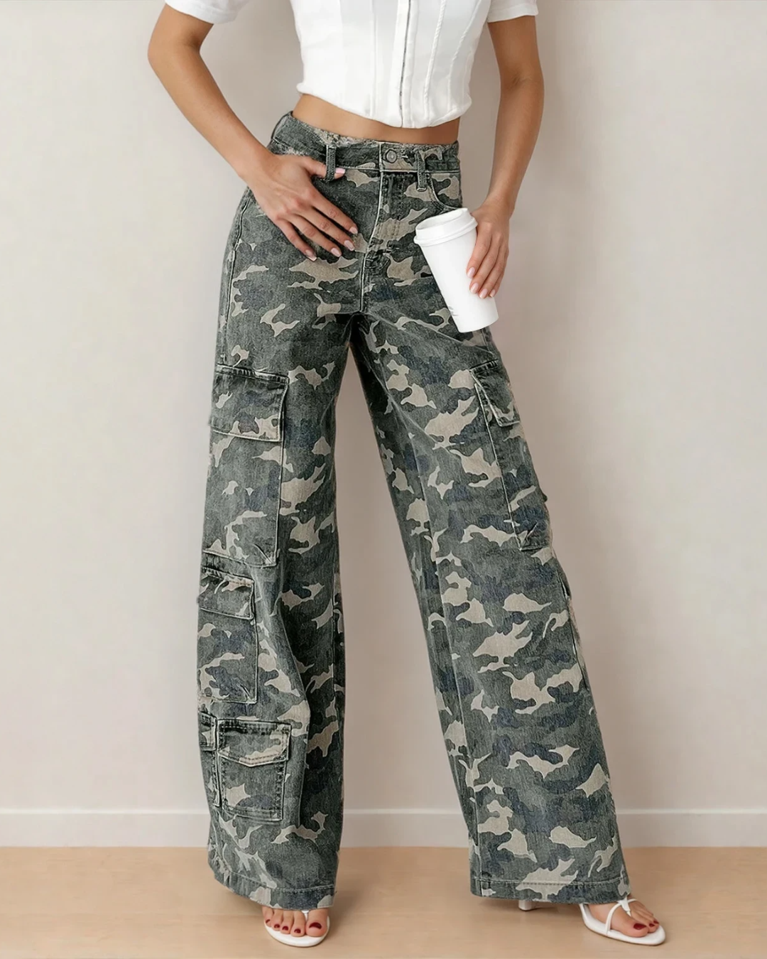 Front view of Peyton green camo wide-leg cargo jeans featuring multiple utility pockets, a high waist with button closure, and a relaxed, oversized silhouette.