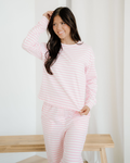 Front view of the Pink Stripe Thea loungewear set, featuring a relaxed-fit drop shoulder round-neck top and matching straight-leg pants with button details.
