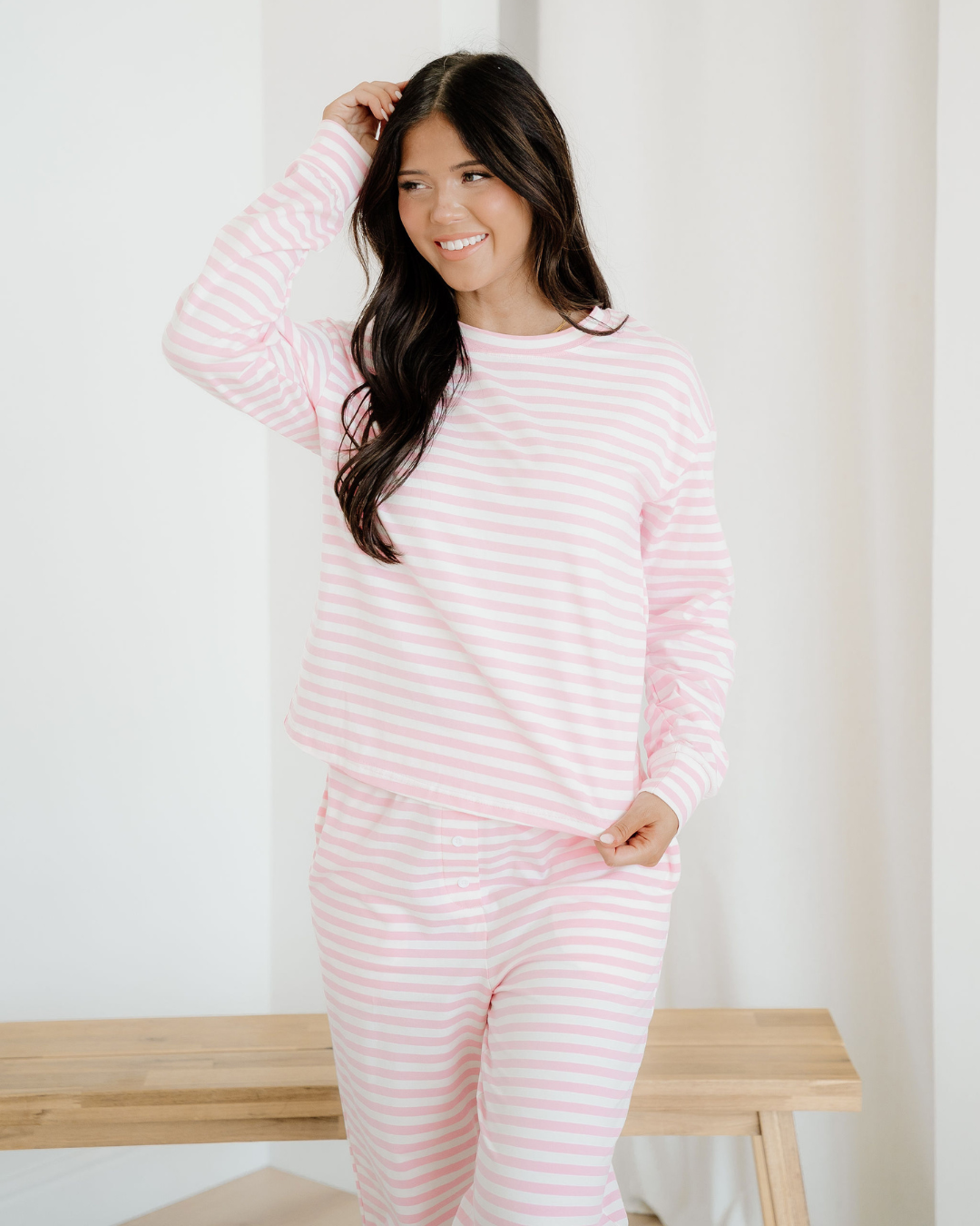 Front view of the Pink Stripe Thea loungewear set, featuring a relaxed-fit drop shoulder round-neck top and matching straight-leg pants with button details.