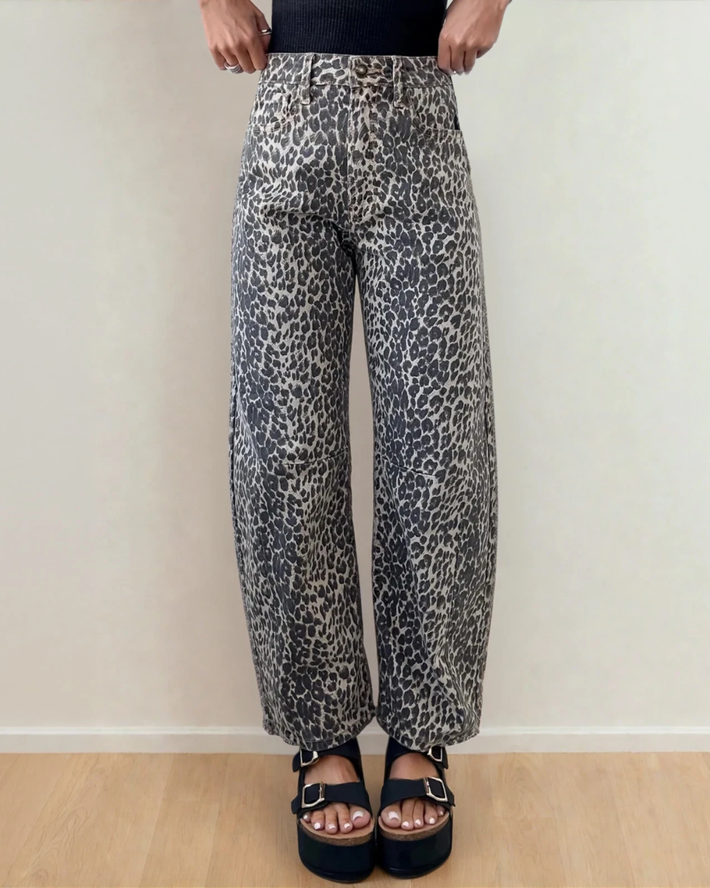 Front view of the Naeve high-waist barrel leg jeans featuring a bold, all-over leopard print pattern, structured front pockets, and a relaxed, tapered leg silhouette.