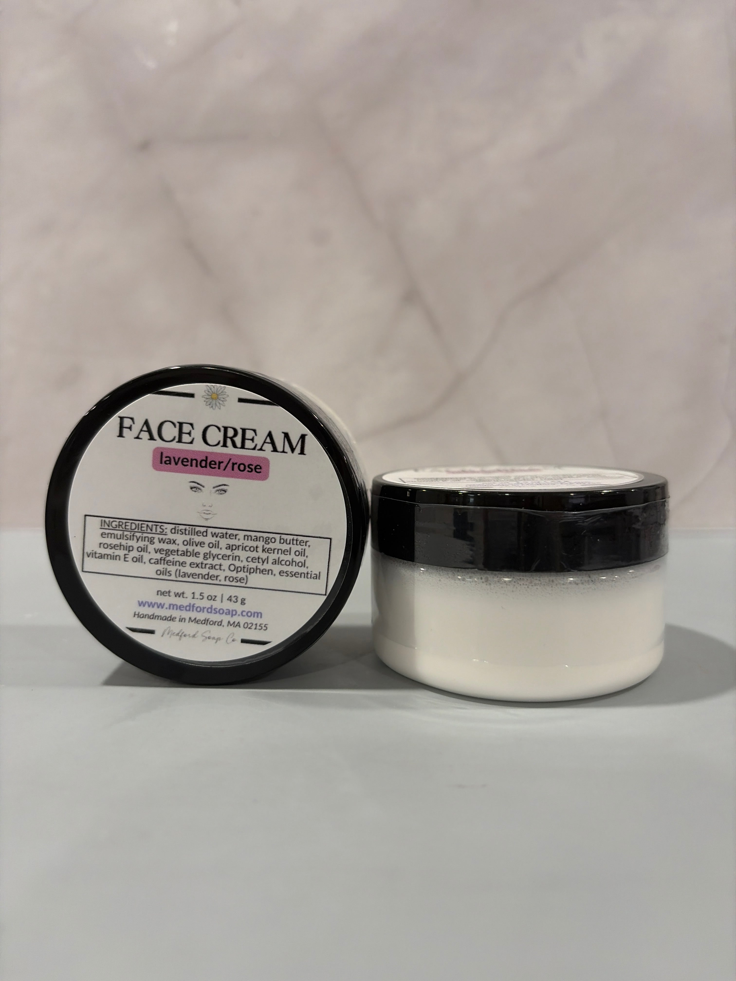 A jar of creamy vegan face cream with mango butter and rosehip oil, handmade by Medford Soap Co. for AllyBay.