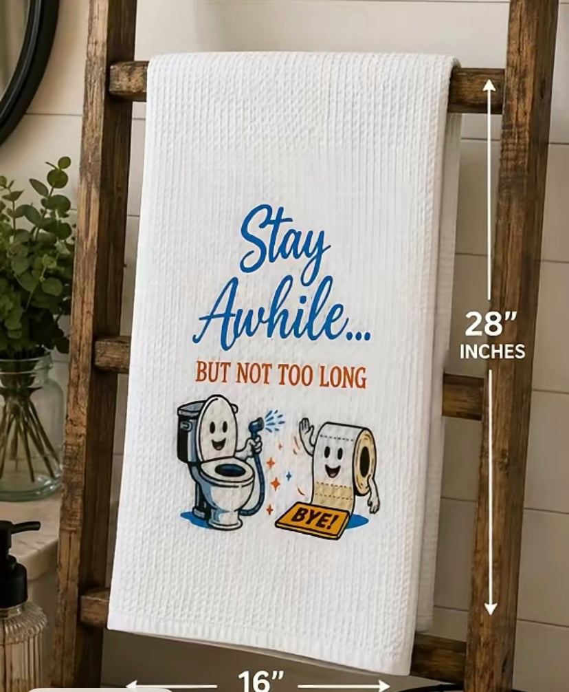 Funny microfiber hand towel with 'Stay Awhile... But Not Too Long' printed design displayed on a decorative wooden ladder in a bathroom
