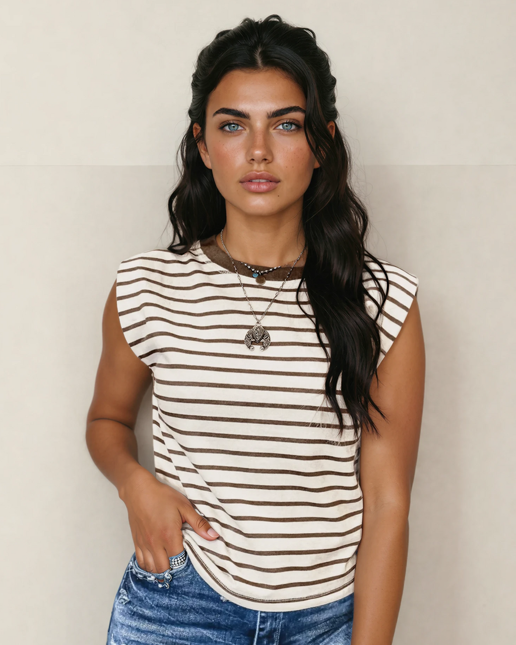 Close-up of a women's earthy brown and cream striped ribbed tank top featuring a solid brown contrast round neckline, displayed on a neutral background.