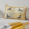 Yellow patchwork bee lumbar accent pillow featuring gingham, honeycomb and vintage bee prints measuring 9.5 x 14 inches.