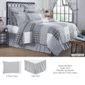Sawyer Mill Charcoal queen bedding bundle featuring a 100% cotton patchwork quilt with rustic gray, black, and cream stripes and plaids styled on a queen bed.