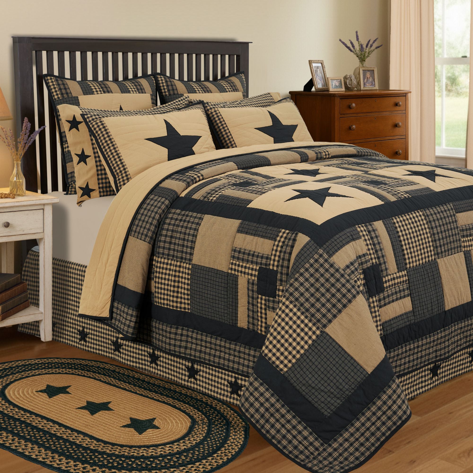 Close-up of a premium black star primitive patchwork quilt showing detailed hand-quilting, textured charcoal and cream cotton fabrics.