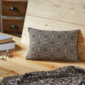 Black and tan jacquard lumbar accent pillow featuring a woven floral pattern measuring 9.5 x 14 inches.