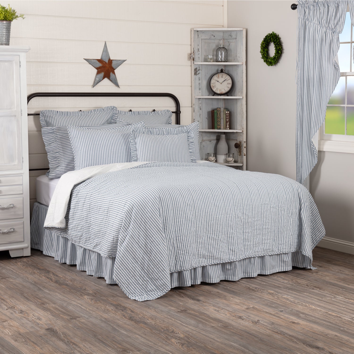 Sawyer Mill Blue Ticking Stripe Quilt Coverlet on a farmhouse-style bed with matching shams.