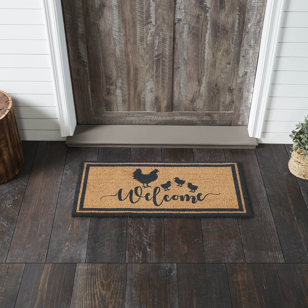 Rectangular natural tan coir doormat featuring a black stencil of a hen followed by three small chicks and the words "Down Home" in a rustic script font.