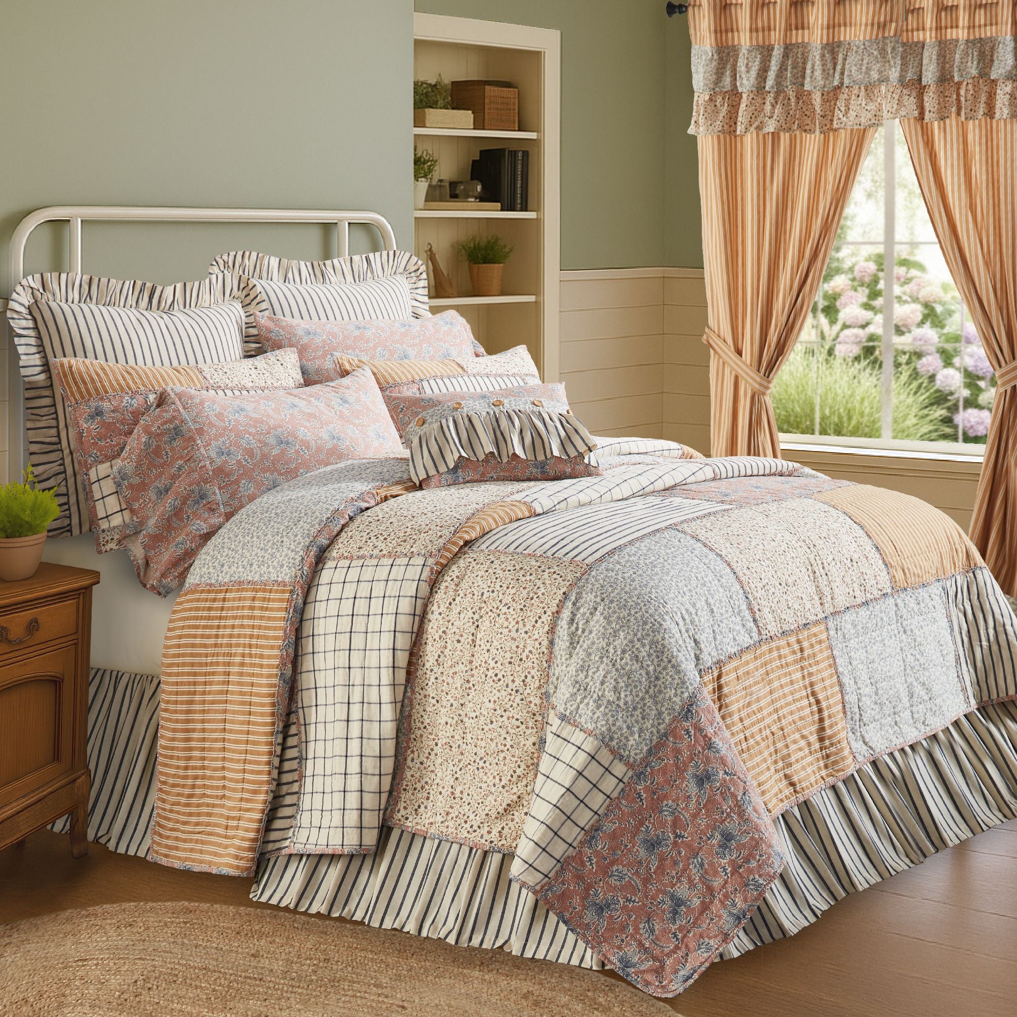 Handcrafted patchwork quilt featuring vintage country floral, stripe, and windowpane plaid blocks in navy blue, gold, and dusty rose with ruffled seam details.