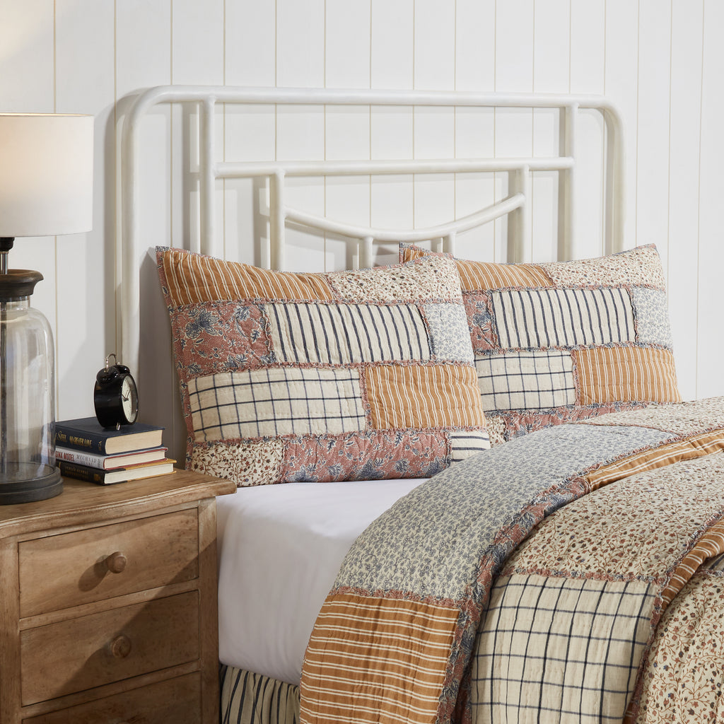 Handcrafted cotton-linen pillow sham featuring vintage country block patchwork in navy, gold, and dusty rose with ruffled trim and tie closures.
