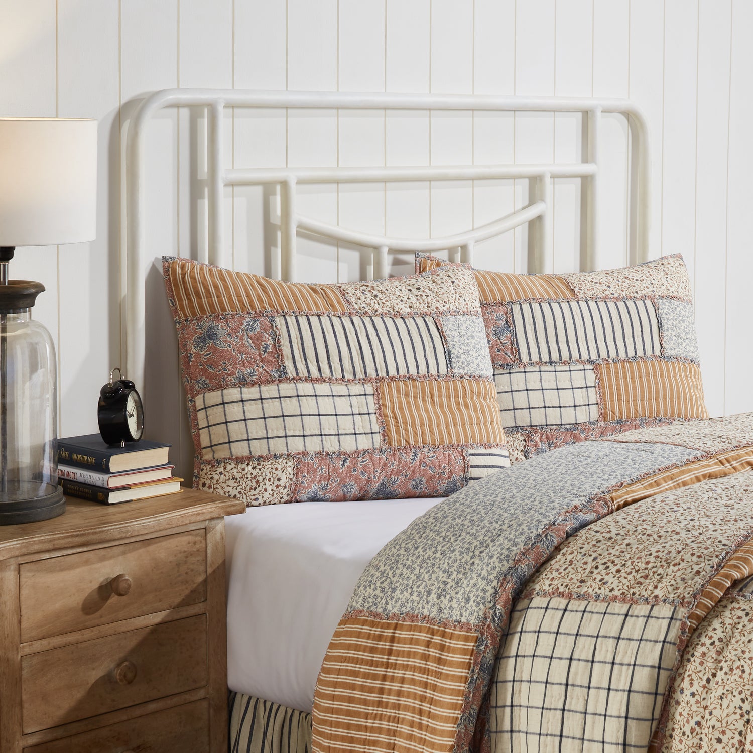 Handcrafted cotton-linen pillow sham featuring vintage country block patchwork in navy, gold, and dusty rose with ruffled trim and tie closures.