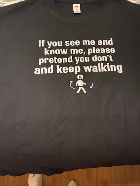 Black graphic t-shirt with "Keep On Walking" printed in white vintage-style text.