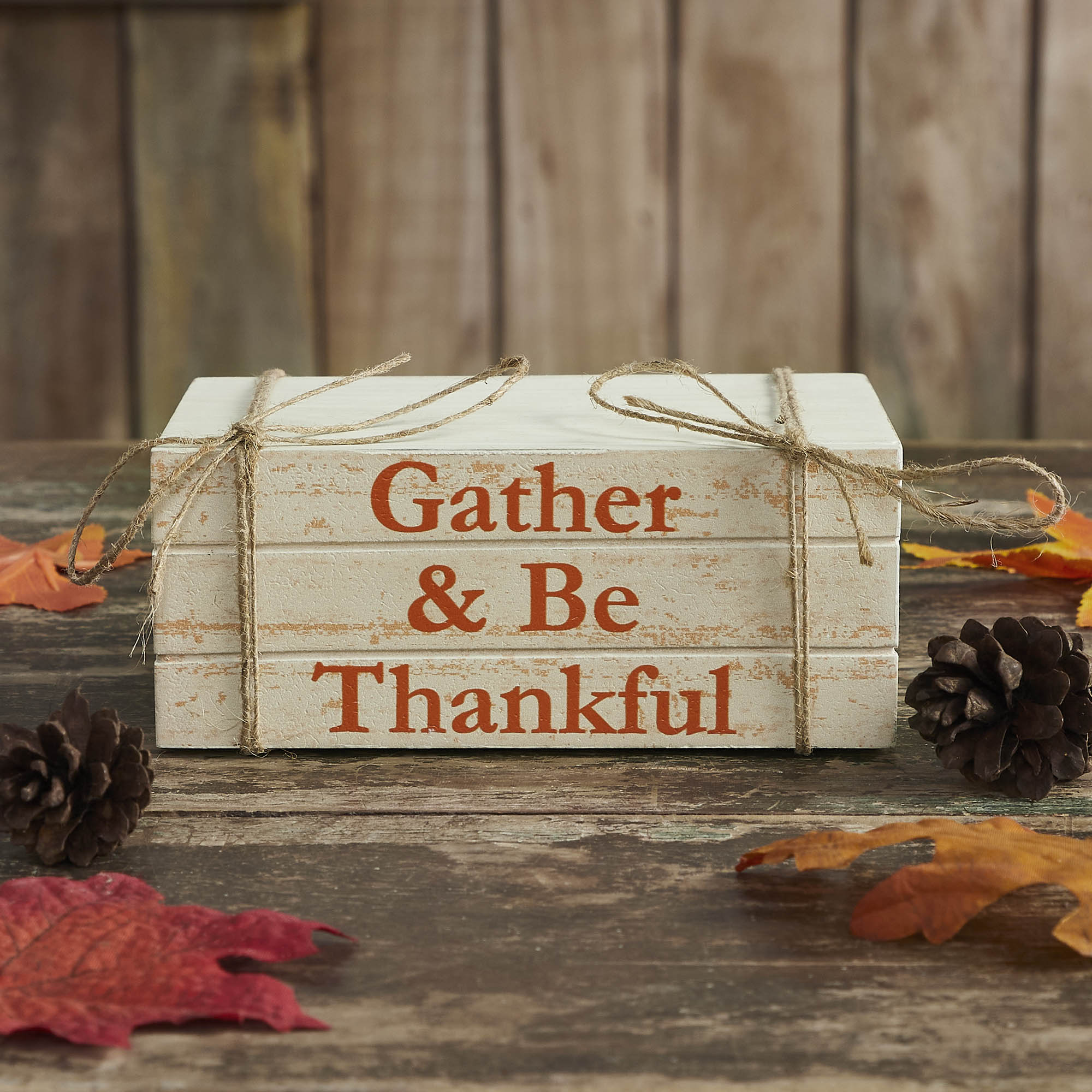 Rustic faux wooden book stack with the phrase "Gather & Be Thankful," distressed white finish, and jute twine measuring 6 x 4 x 2.5 inches.