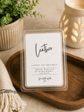 Package of Leather soy wax melts sitting next to a ceramic wax warmer on a rustic surface.