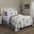 VHC Brands Lydia Blue floral cotton quilt with country blue botanical patterns and a reversible blue check design on a farmhouse bed.