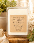 Clamshell package of Morning Light soy wax melts sitting on a wooden coaster next to a potted green plant in a bright, sunlit room.