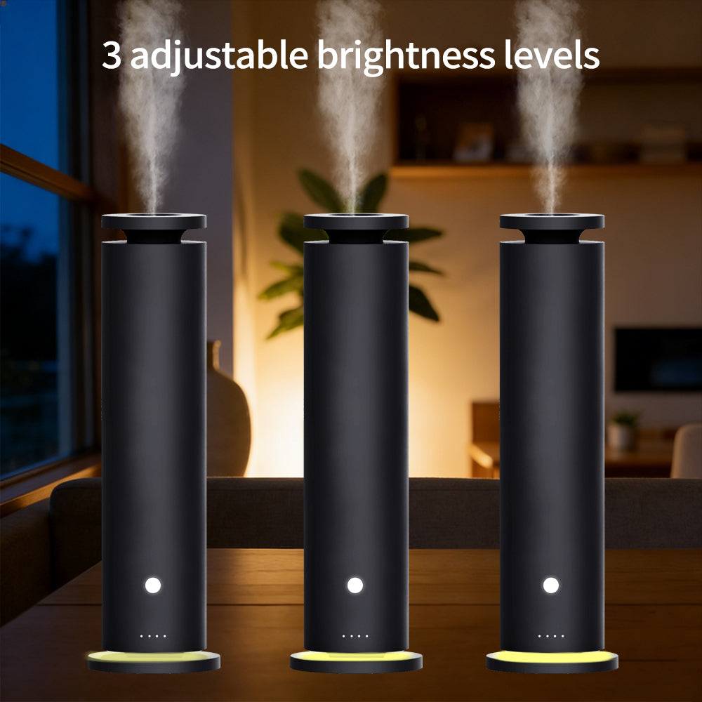 Black cold-air scent diffuser standing upright with light mist vapor rising from the top, demonstrating three adjustable ambient light brightness levels along its base.