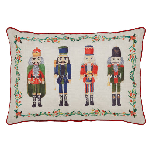 Front view of the lumbar pillow showcasing the line of detailed nutcracker soldiers embroidered on neutral fabric.
