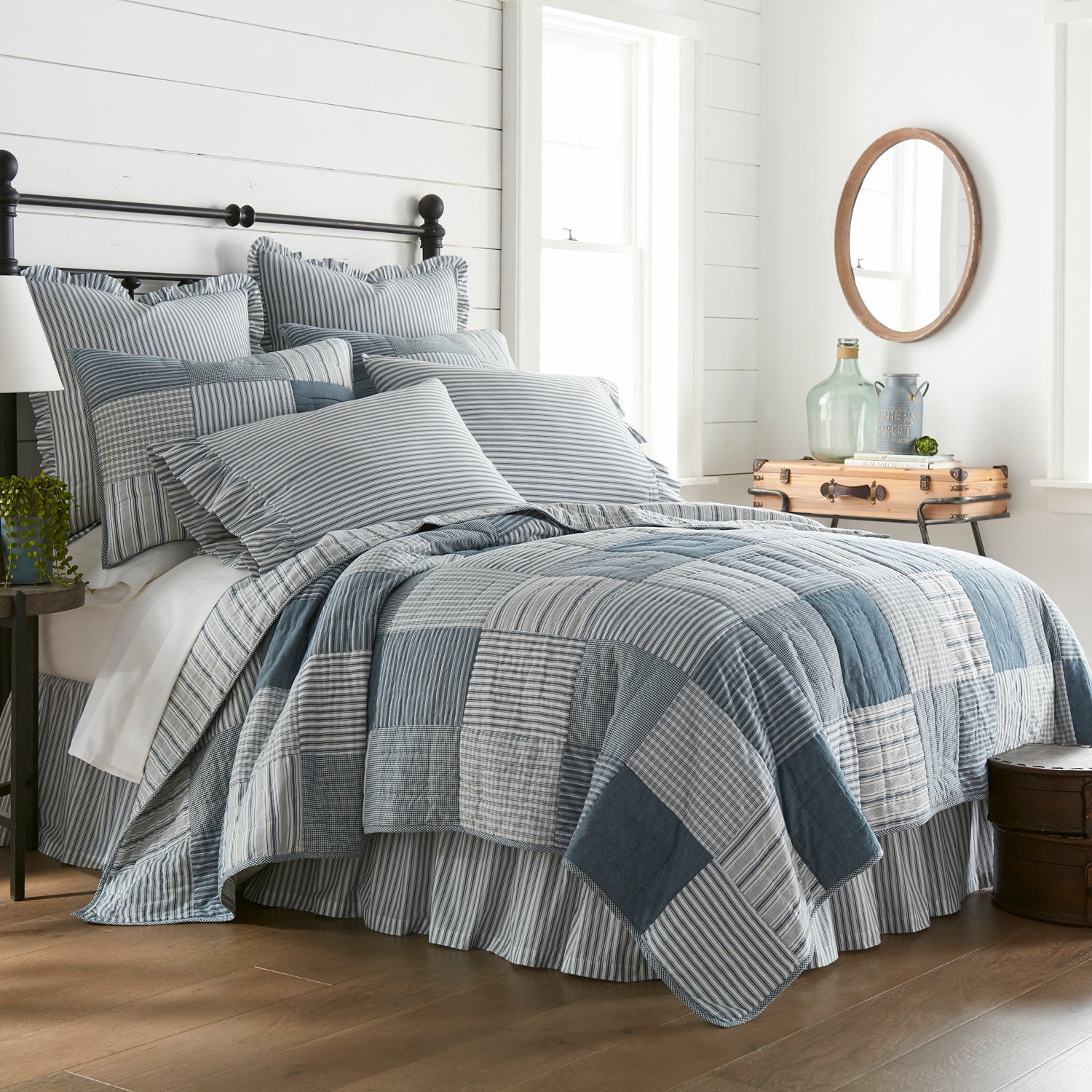 Sawyer Mill Blue King Quilt with indigo patchwork and hand-quilting detail for a sanctuary-style bedroom.