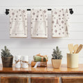 Rustic Christmas tree throw pillow styled on a living room couch alongside festive holiday decor.