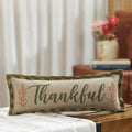 Decorative lumbar accent pillow with 'Thankful' text displayed on a cozy tabletop.
