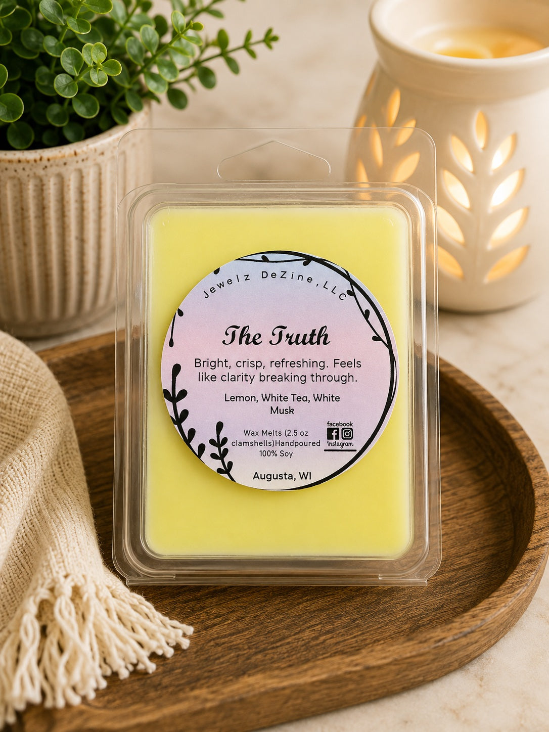 Package of The Truth soy wax melts sitting next to a ceramic wax warmer on a decorative countertop.
